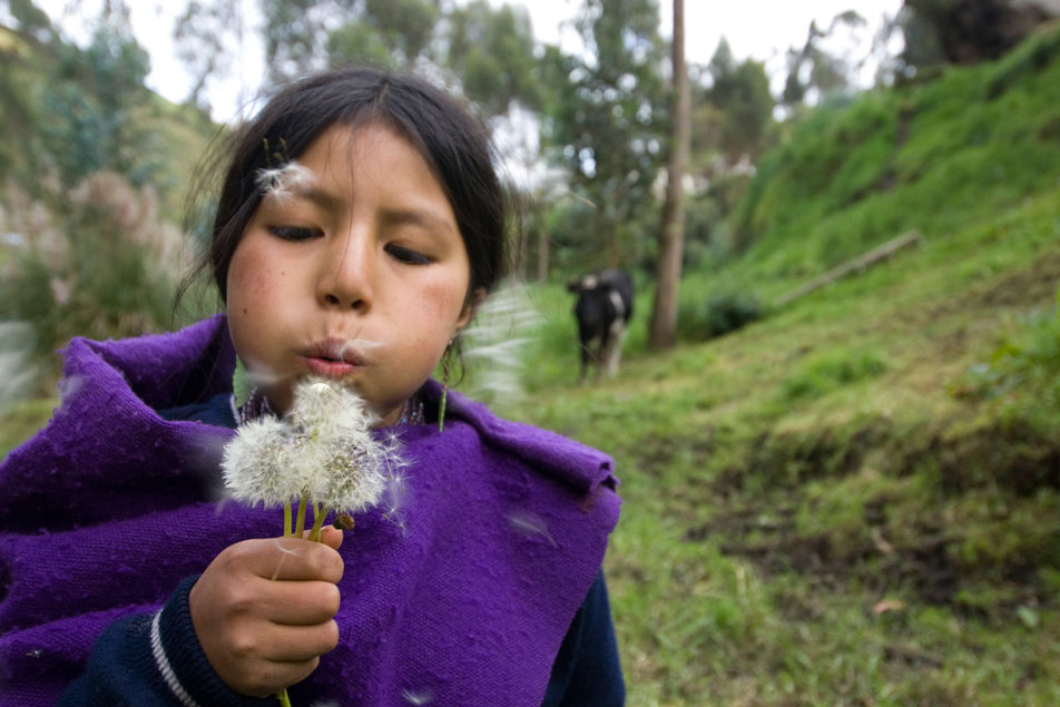 Gloria did a few somersaults down a steep hill and picked some dandelions to blow my way before beginning her daily chore of milking the family cow. After she milks the cow, Gloria carries a large jug back up the hill and down the road to a small cheese-making facility in the village.