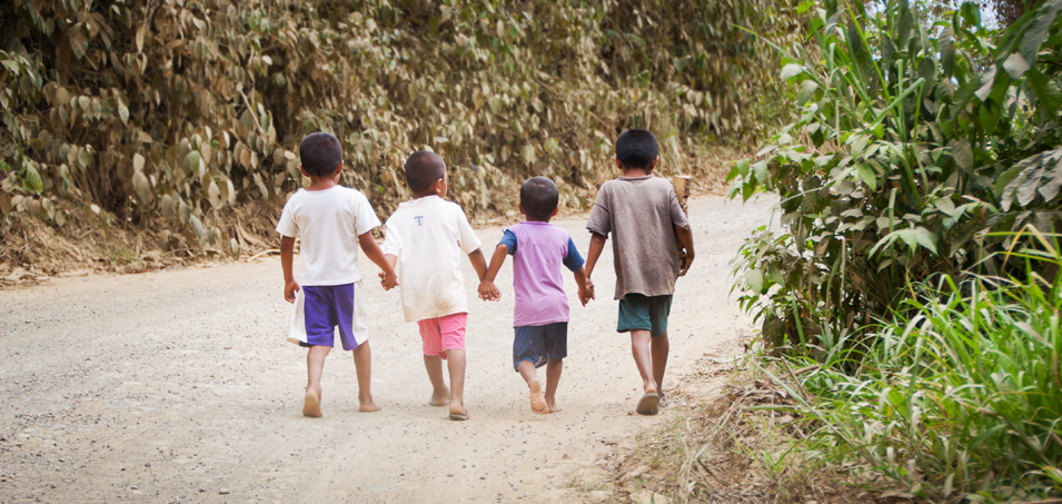 Four little friends hold hands as they walk home to Ocho de Augusto, a small indigenous farming community in Guatemala's Polochic Valley. The people here are currently risking their lives, having been evicted once before, in an effort to gain title to the government land that they are currently occupying.